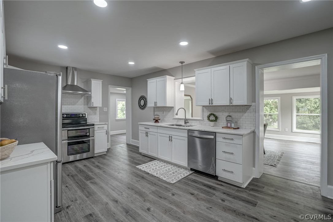 5304 River Road West Goochland, VA 23063 - Photo 25 of 47 a kitchen with white cabinets and stainless steel appliances