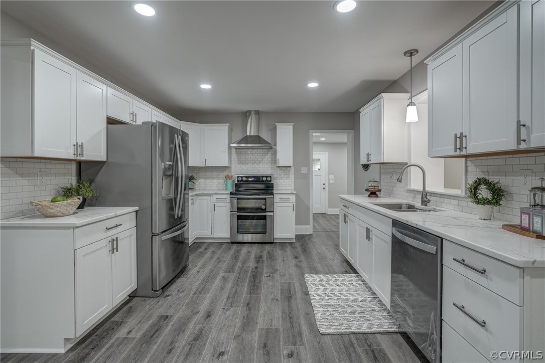 5304 River Road West Goochland, VA 23063 - Photo 28 of 47 a kitchen with granite countertop a refrigerator oven a sink dishwasher and white cabinets with wooden floor