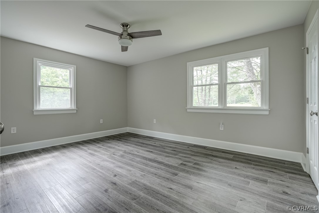5304 River Road West Goochland, VA 23063 - Photo 33 of 47 an empty room with wooden floor fan and windows