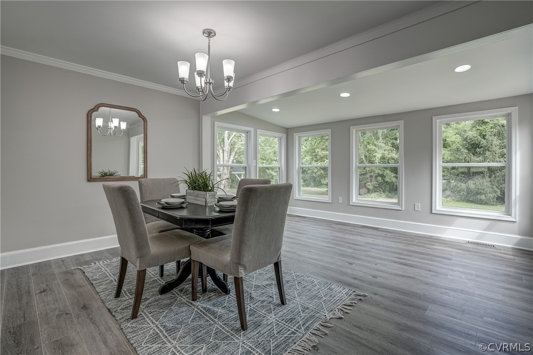 5304 River Road West Goochland, VA 23063 - Photo 36 of 47 a dining room with wooden floor a chandelier a wooden table and chairs