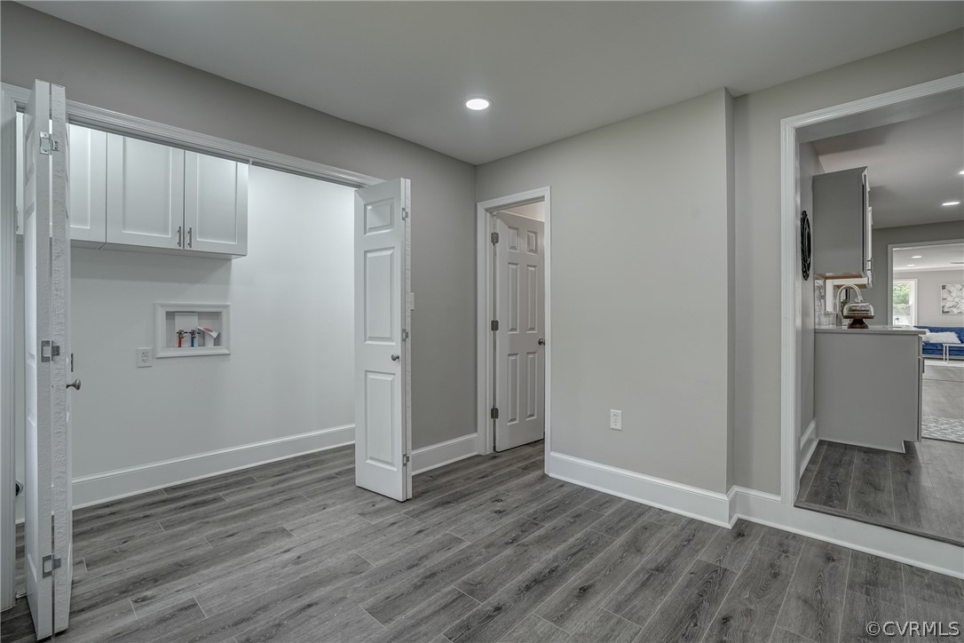 5304 River Road West Goochland, VA 23063 - Photo 43 of 47 an empty room with wooden floor and a kitchen