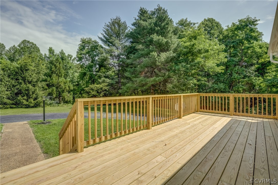 5304 River Road West Goochland, VA 23063 - Photo 9 of 47 a balcony with wooden floor and trees in the background