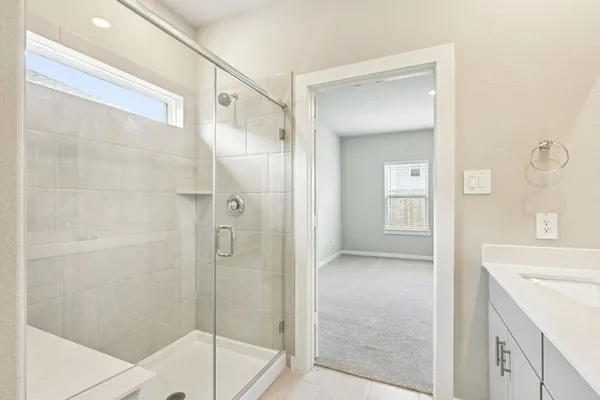 a bathroom with a shower and a sink