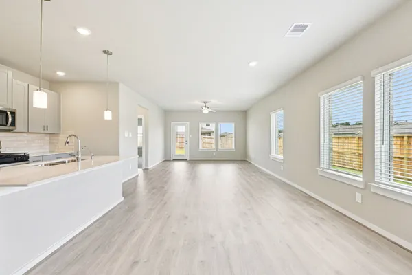 a large space with chandelier and windows in a room