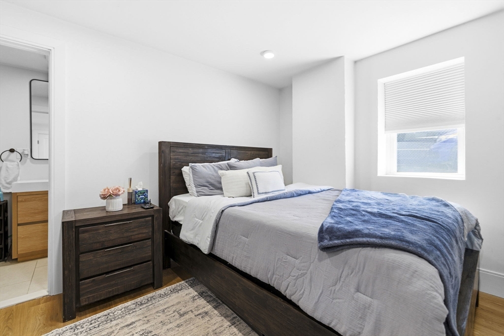 92 Chelsea Street, Unit 1 Boston, MA 02128 - Photo 9 of 14 a bedroom with a bed and a window