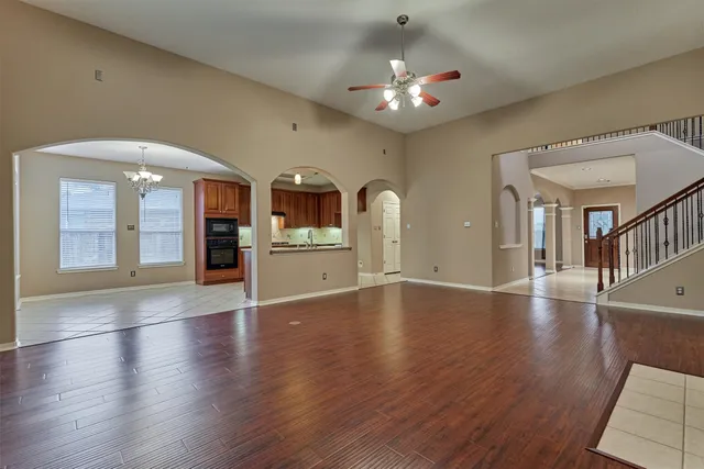 wooden floor in an empty room with a kitchen