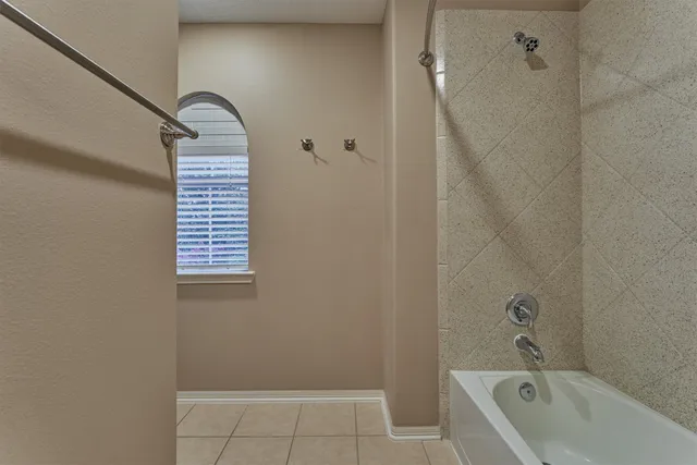 a bathroom with a bathtub and shower