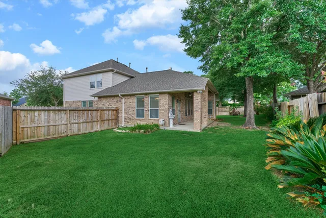 a front view of a house with yard and green space
