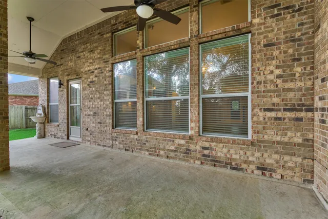 a view of a brick house with a large windows