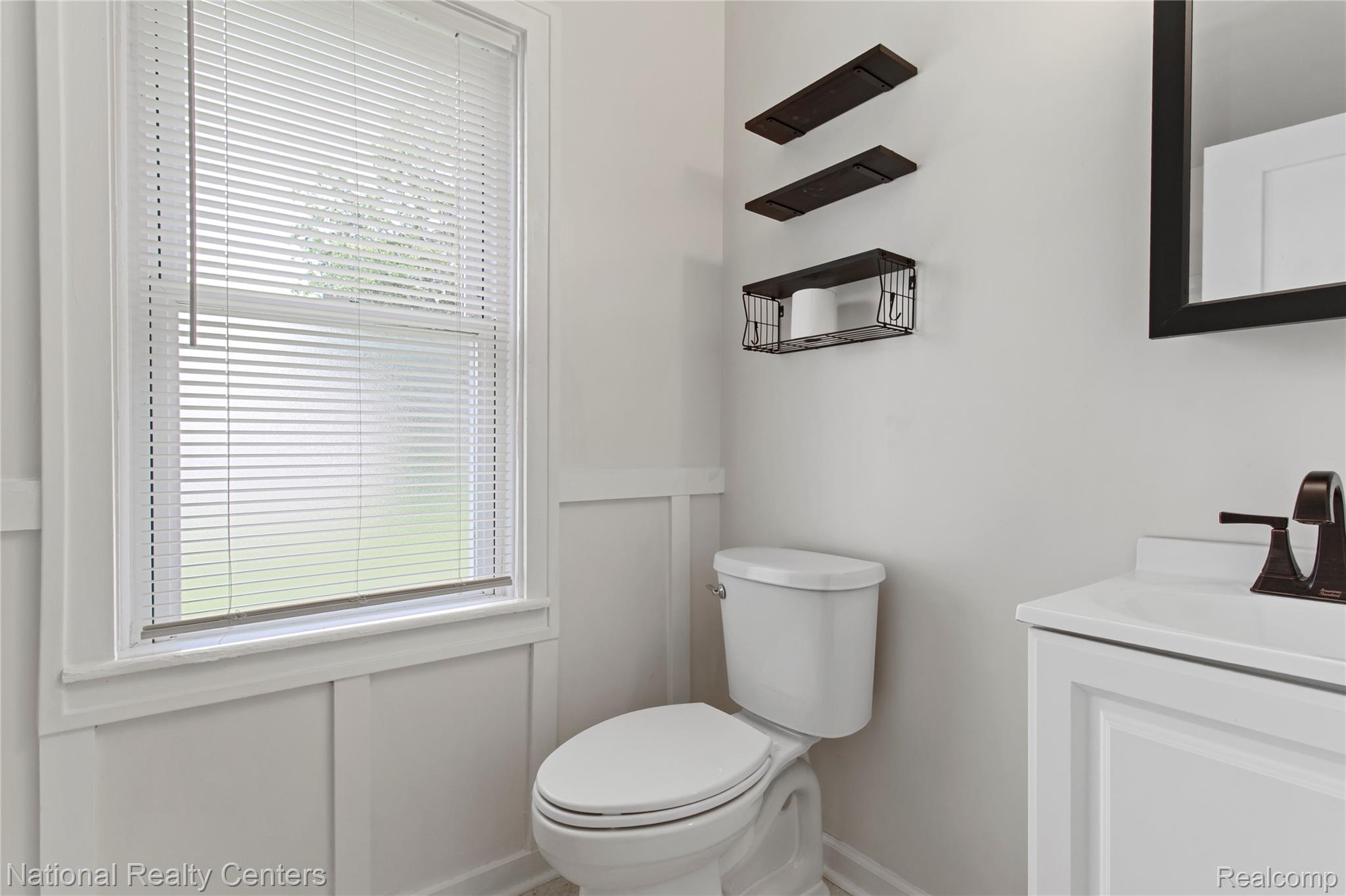 26862 Yale Street Inkster, MI 48141 - Photo 20 of 34 Bathroom featuring a white vanity with integrated sink, bronze-finish faucet, and a framed mirror