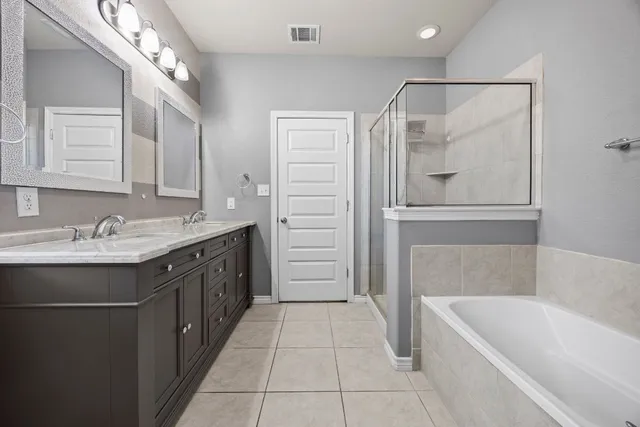 a bathroom with a tub sink and mirror