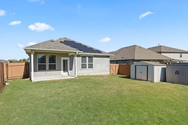 a front view of a house with a garden and yard