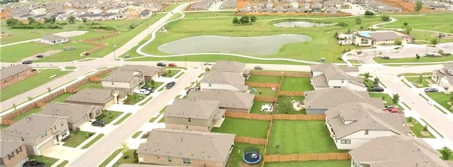 an aerial view of a building with an outdoor space