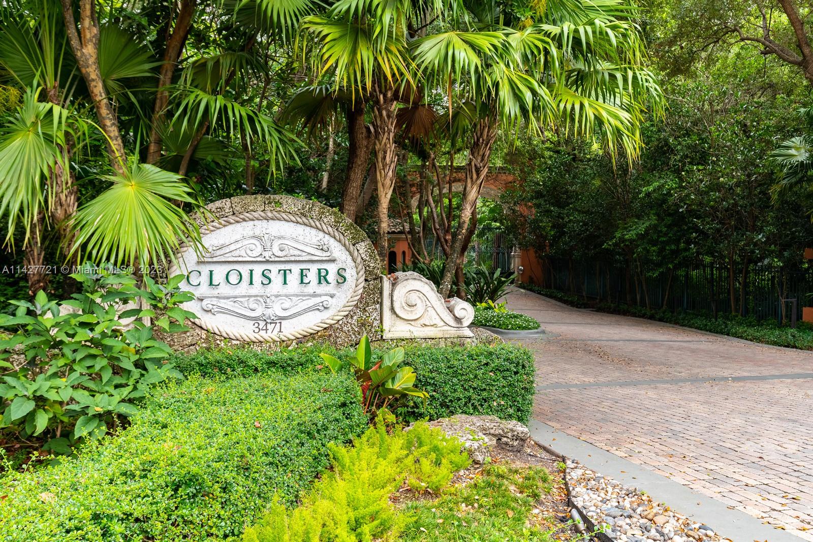 a sign that is sitting in front of flowers