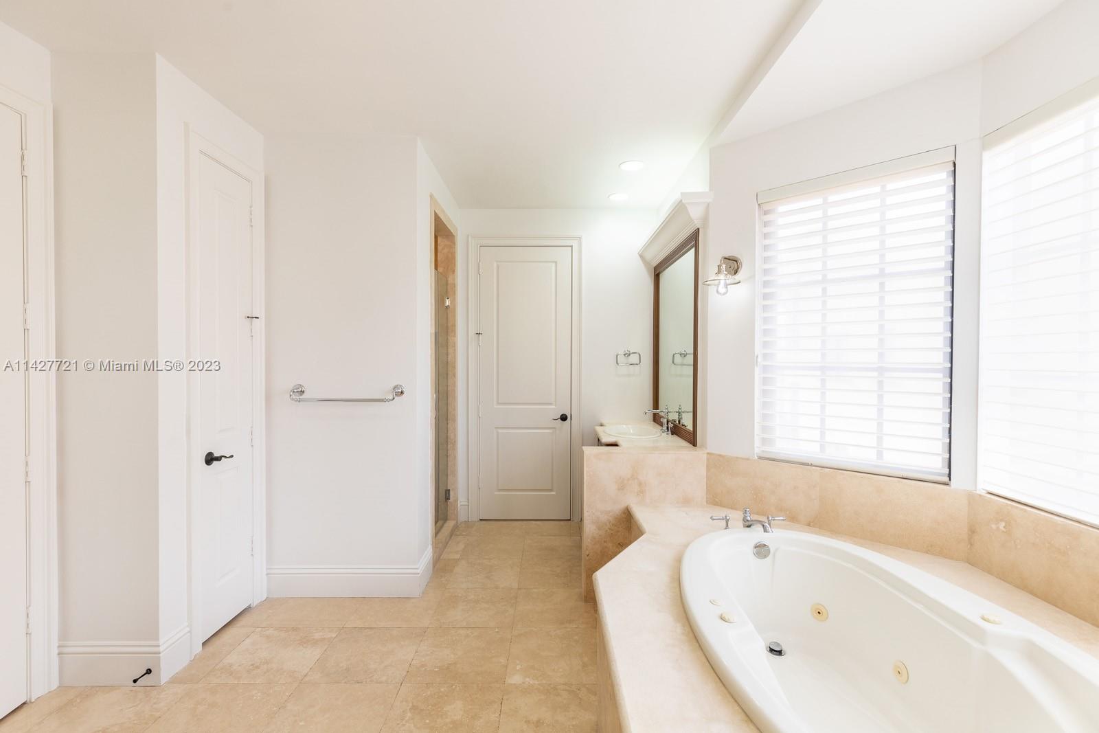 3471 Main Highway, Unit 928 Miami, FL 33133 - Photo 12 of 40 a bathroom with a tub shower and sink