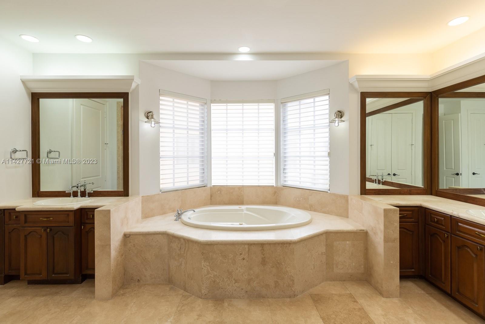 3471 Main Highway, Unit 928 Miami, FL 33133 - Photo 13 of 40 a bath tub sitting in a bathroom next to a window