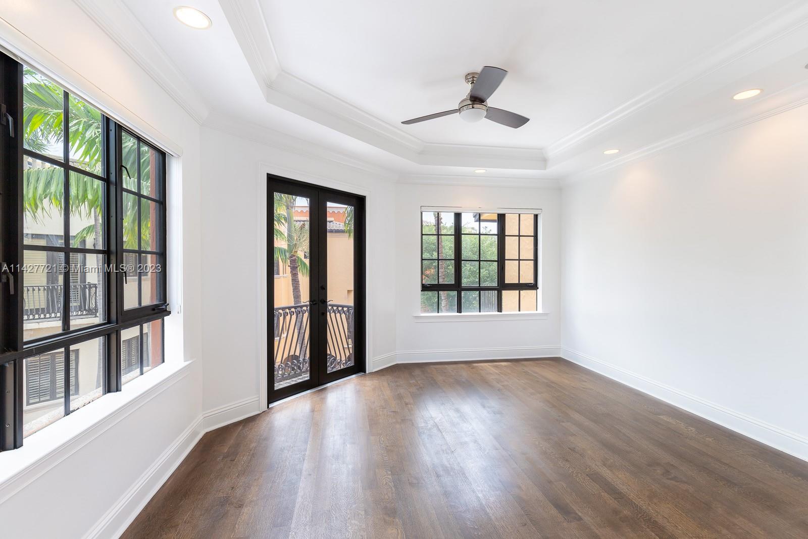 3471 Main Highway, Unit 928 Miami, FL 33133 - Photo 21 of 40 a view of an empty room with wooden floor and a window