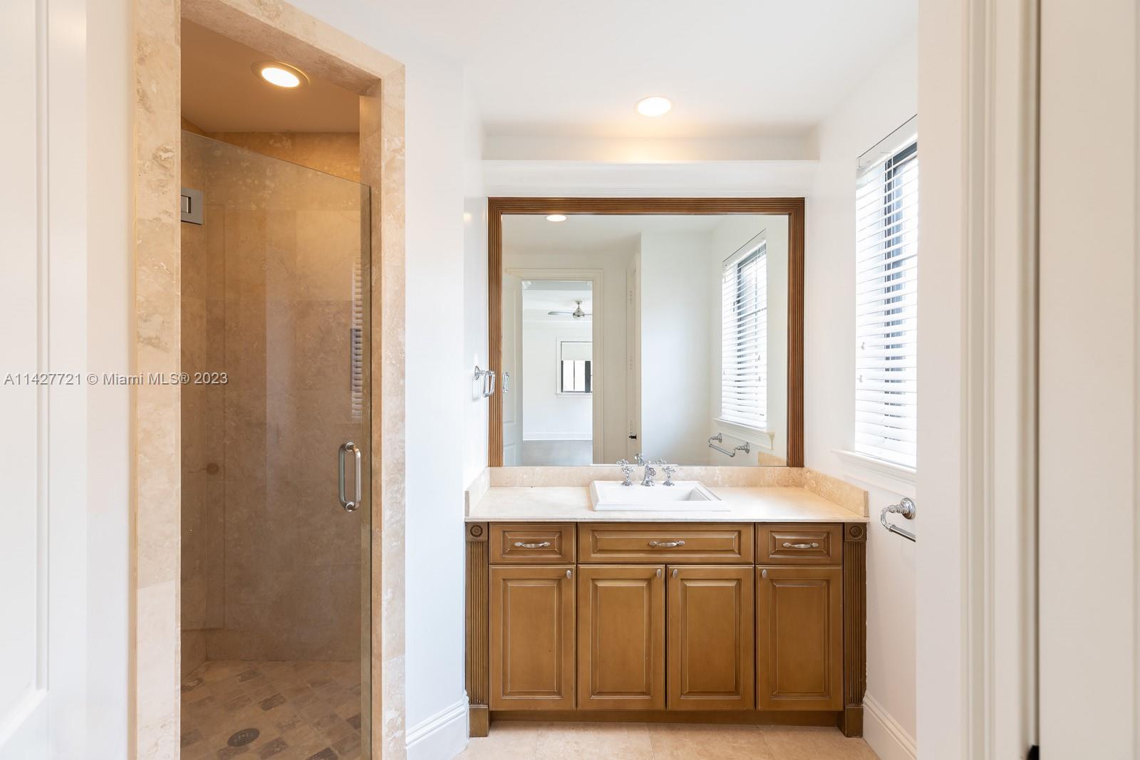 3471 Main Highway, Unit 928 Miami, FL 33133 - Photo 24 of 40 a bathroom with a sink and a mirror