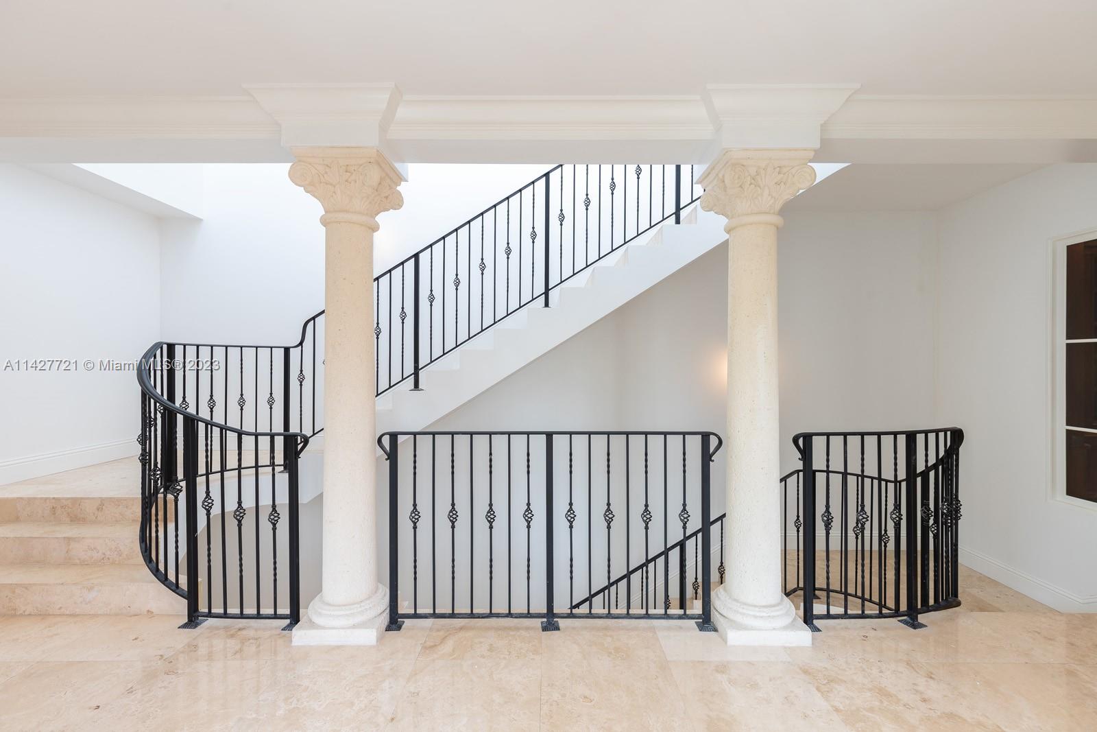 3471 Main Highway, Unit 928 Miami, FL 33133 - Photo 3 of 40 a view of staircase with railing and white walls