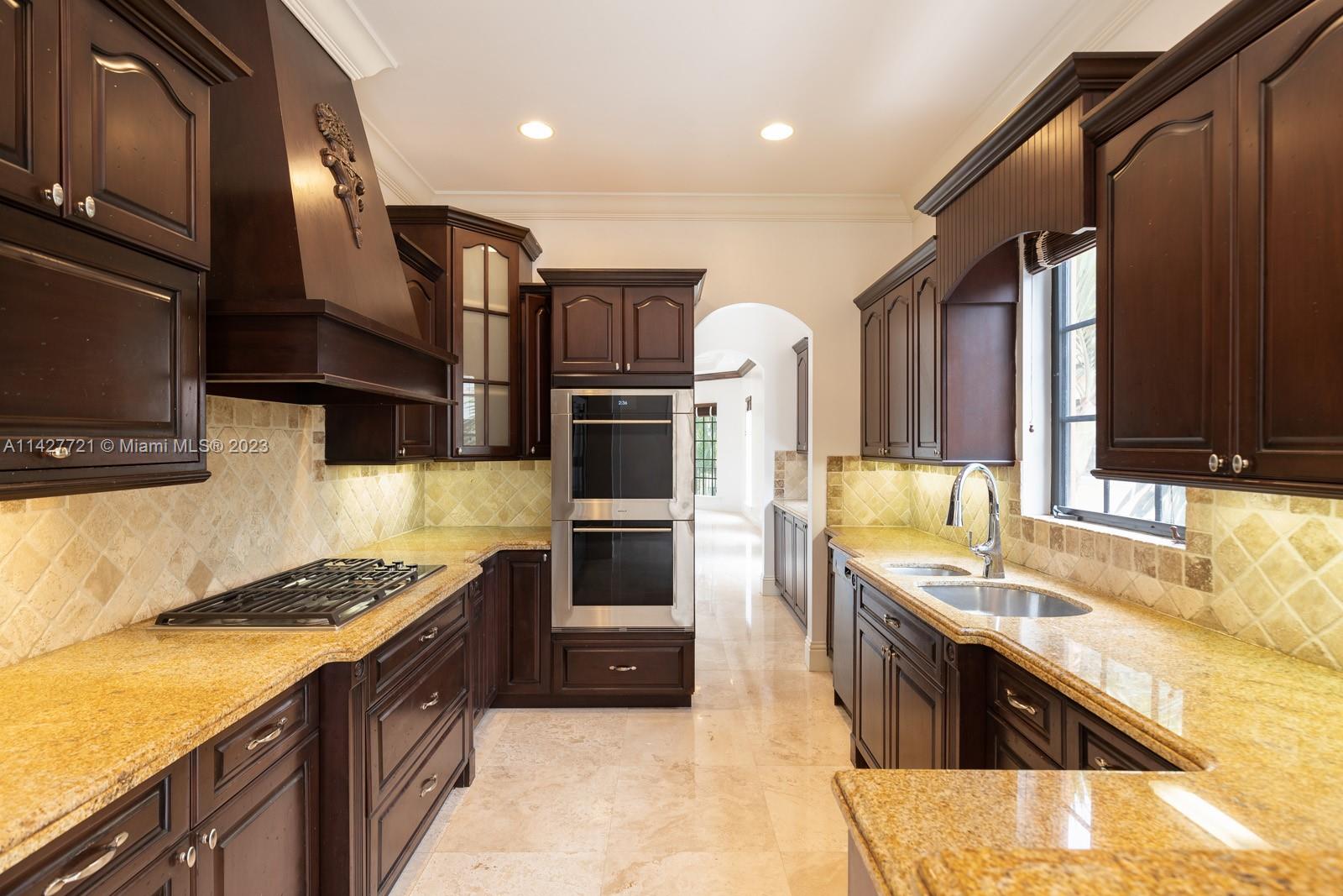3471 Main Highway, Unit 928 Miami, FL 33133 - Photo 10 of 40 a kitchen with stainless steel appliances granite countertop a sink stove and refrigerator