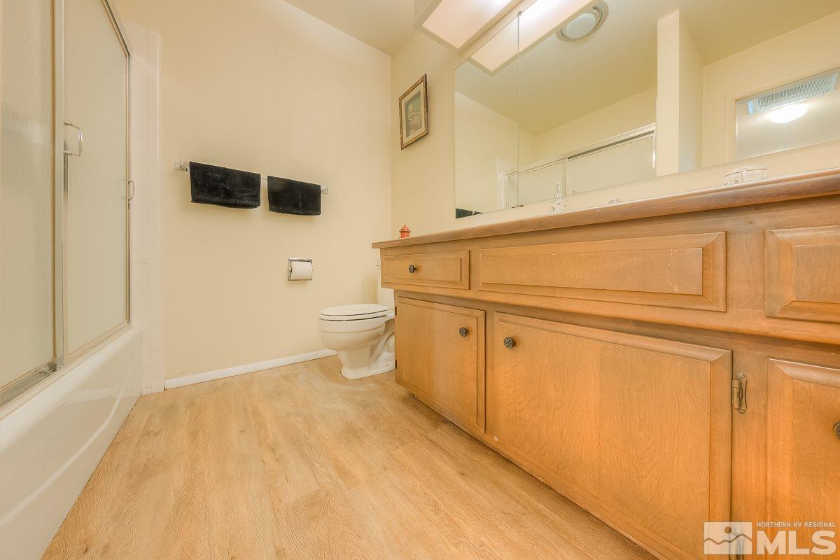 2001 Branch Reno, NV 89509 - Photo 15 of 25 a bathroom with a toilet a sink a mirror and vanity