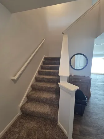 a view of entryway and hall with wooden floor