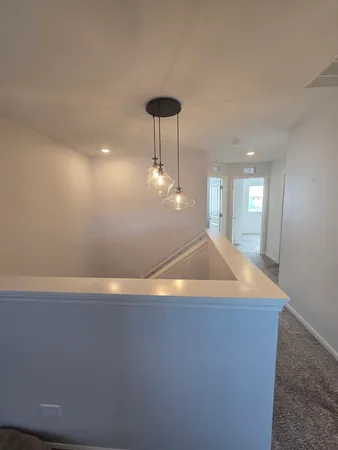 a room with wooden floor and chandelier
