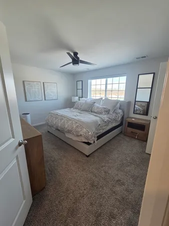 a bedroom with a bed and a window