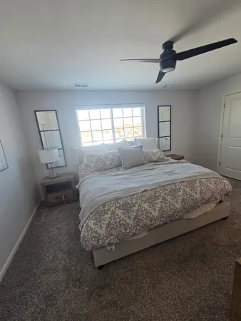 a bedroom with a bed and a window