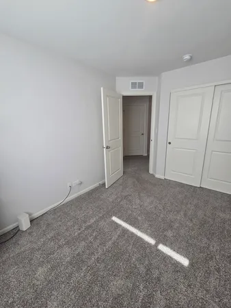 a view of an empty room and closet area