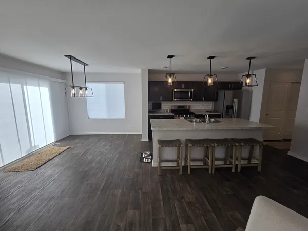 a dining room with furniture and wooden floor