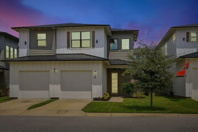 a kitchen with stainless steel appliances granite countertop a dining table chairs stove refrigerator and cabinets