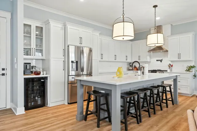 a living room with furniture a dining table and a window
