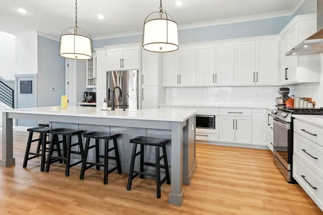 a living room with furniture a flat screen tv and a large window