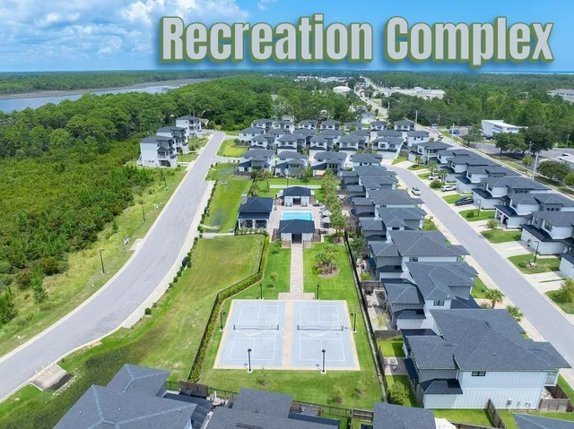 a view of a bedroom with furniture and wooden floor