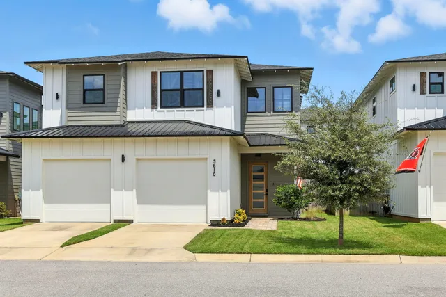 an aerial view of multiple houses with yard