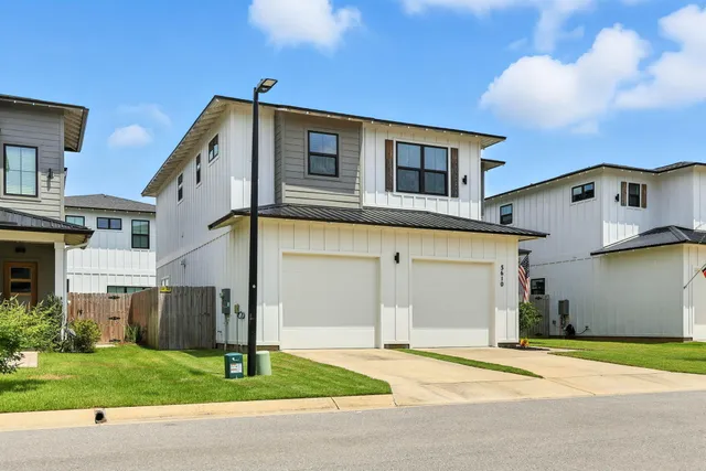 a living room with stainless steel appliances granite countertop furniture wooden floor and a view of kitchen