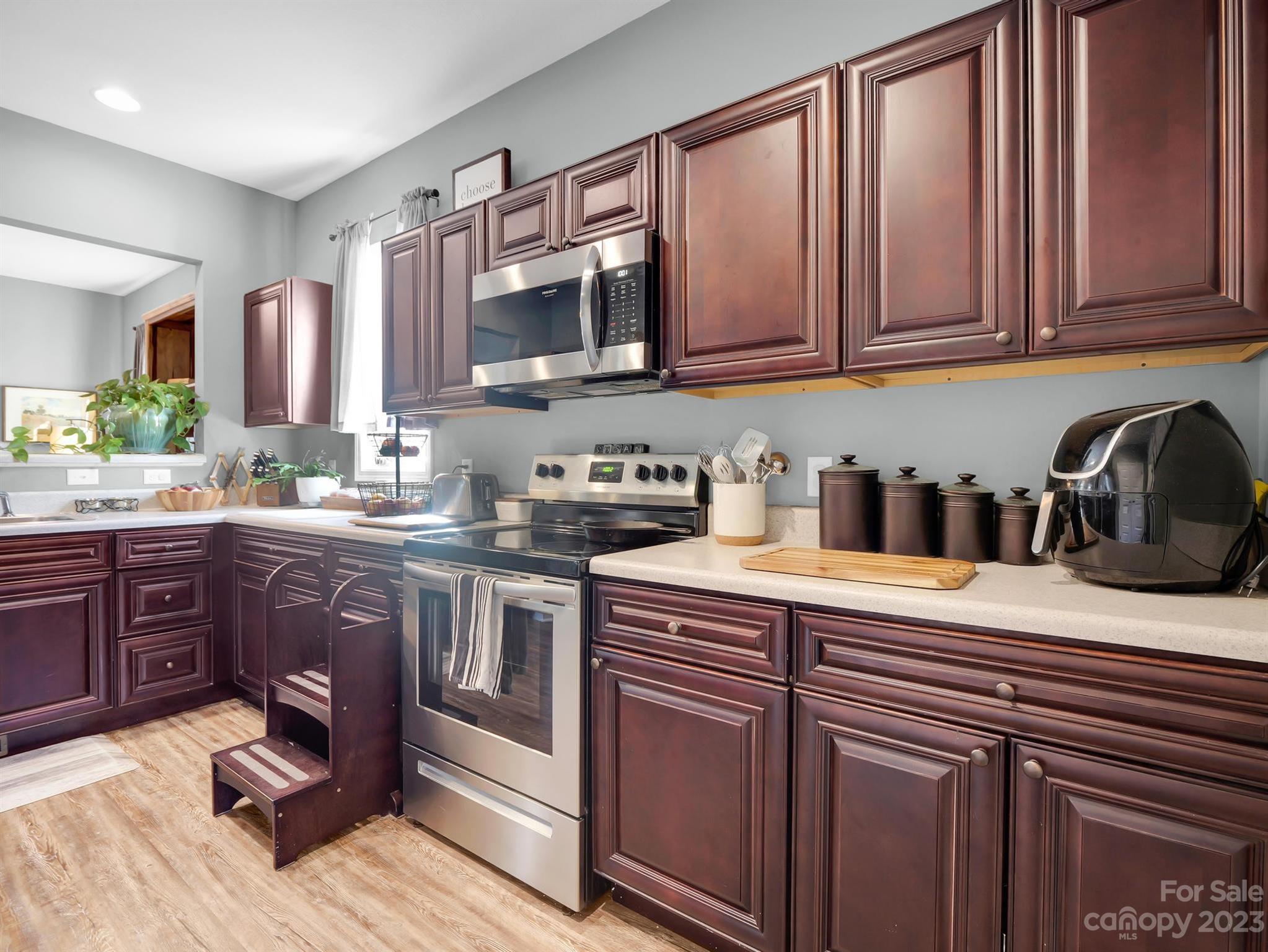 335 Mine Gap Road Flat Rock, NC 28731 - Photo 12 of 40 a kitchen with stainless steel appliances granite countertop a sink stove and microwave