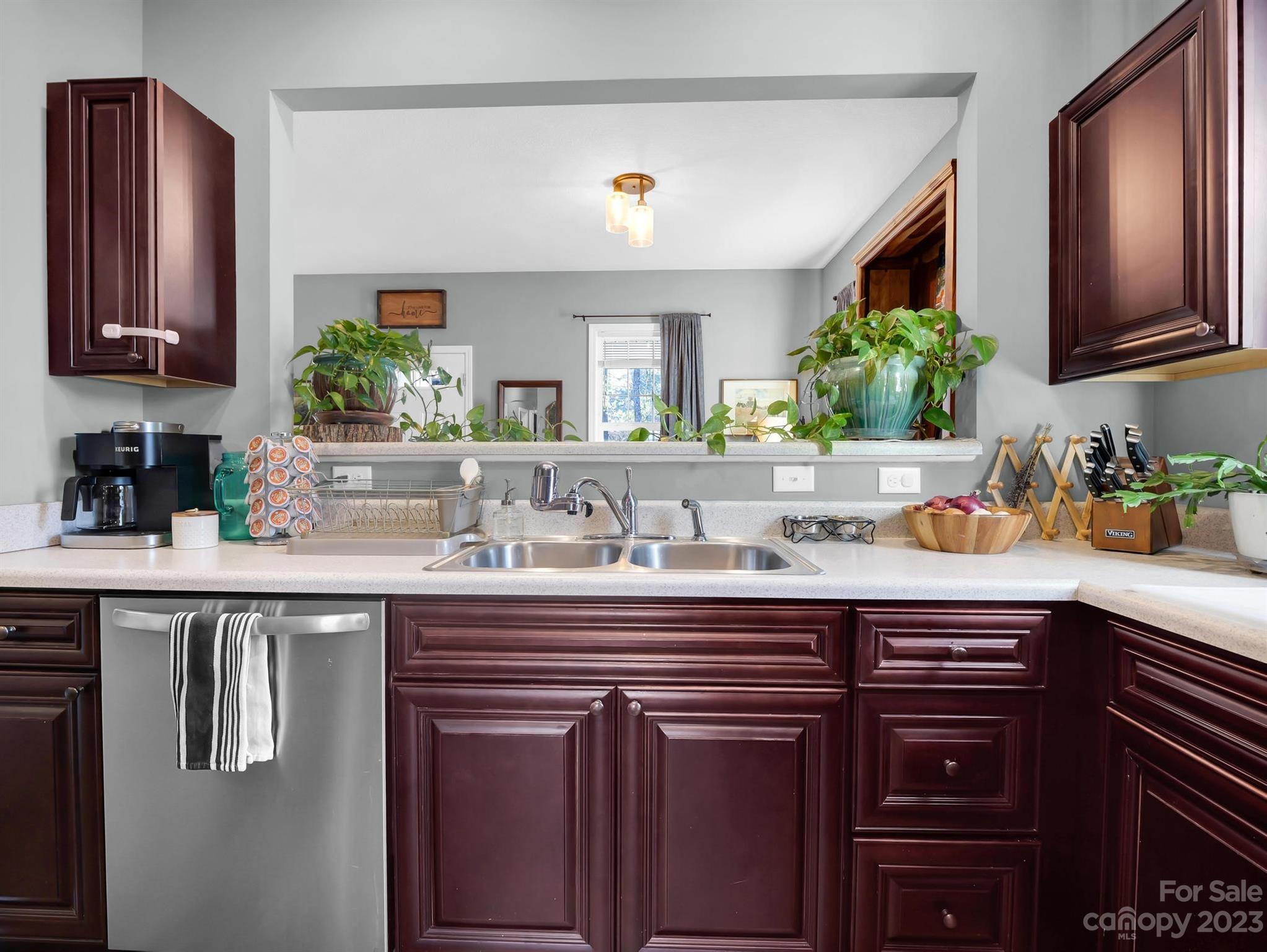 335 Mine Gap Road Flat Rock, NC 28731 - Photo 13 of 40 a kitchen with stainless steel appliances granite countertop a sink and wooden cabinets