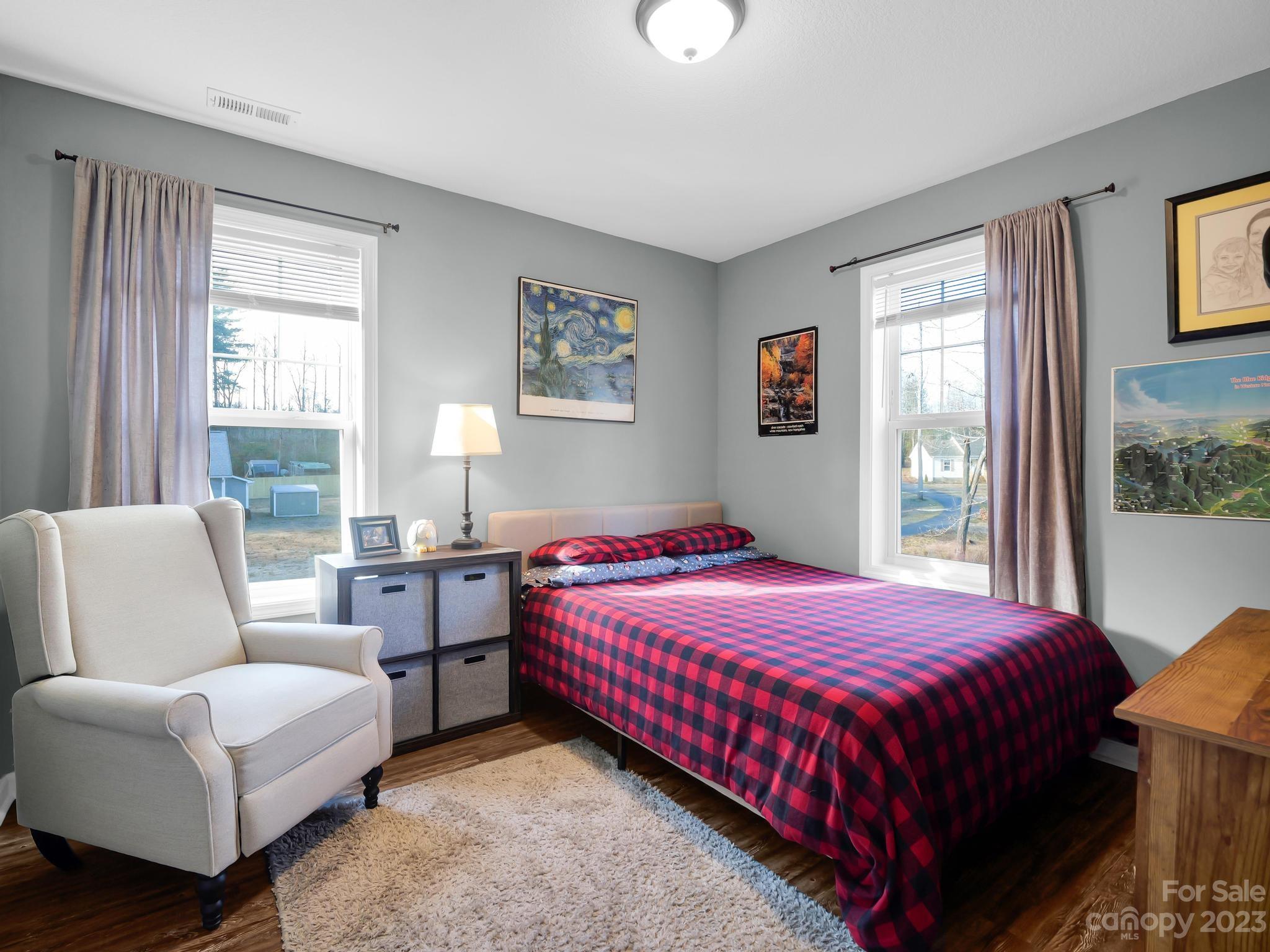 335 Mine Gap Road Flat Rock, NC 28731 - Photo 22 of 40 a bedroom with a bed and a couch