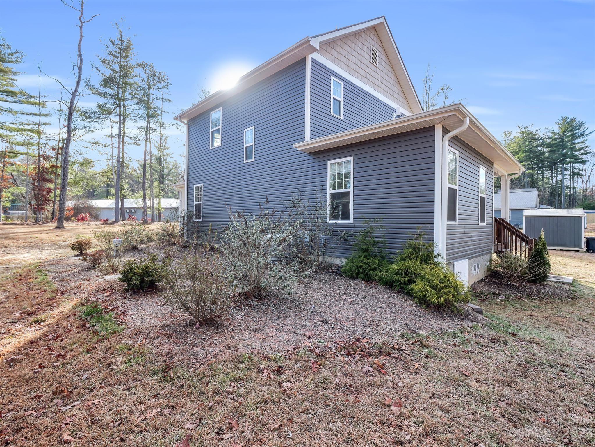 335 Mine Gap Road Flat Rock, NC 28731 - Photo 35 of 40 a view of a house with a yard and floor to ceiling window