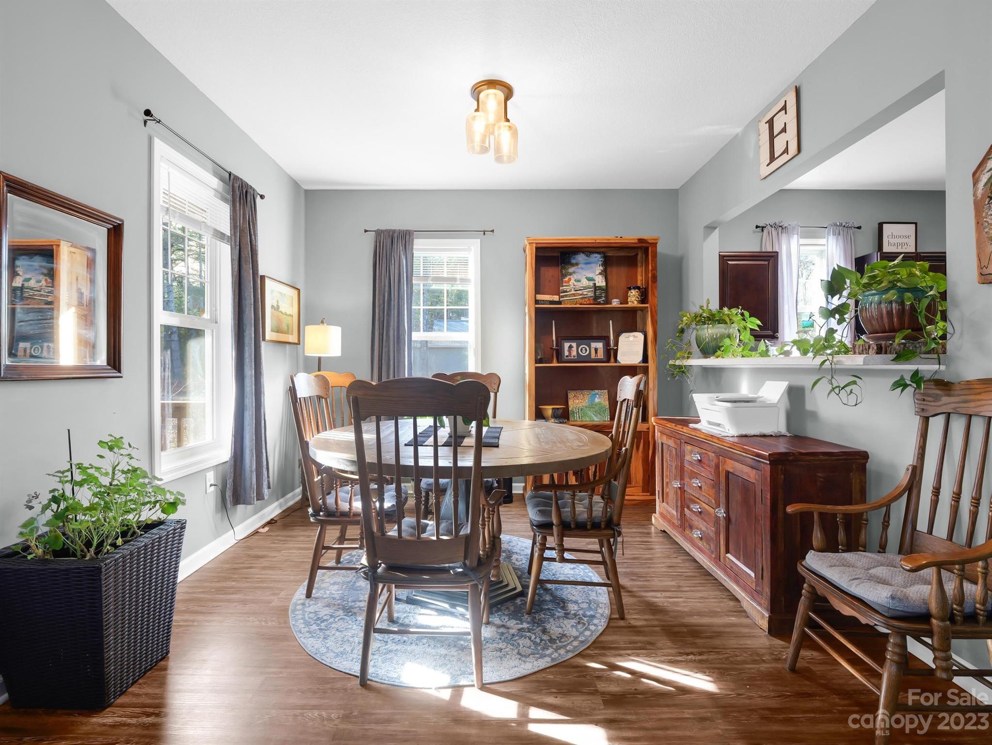 335 Mine Gap Road Flat Rock, NC 28731 - Photo 6 of 40 a view of a dining room with furniture and a potted plant