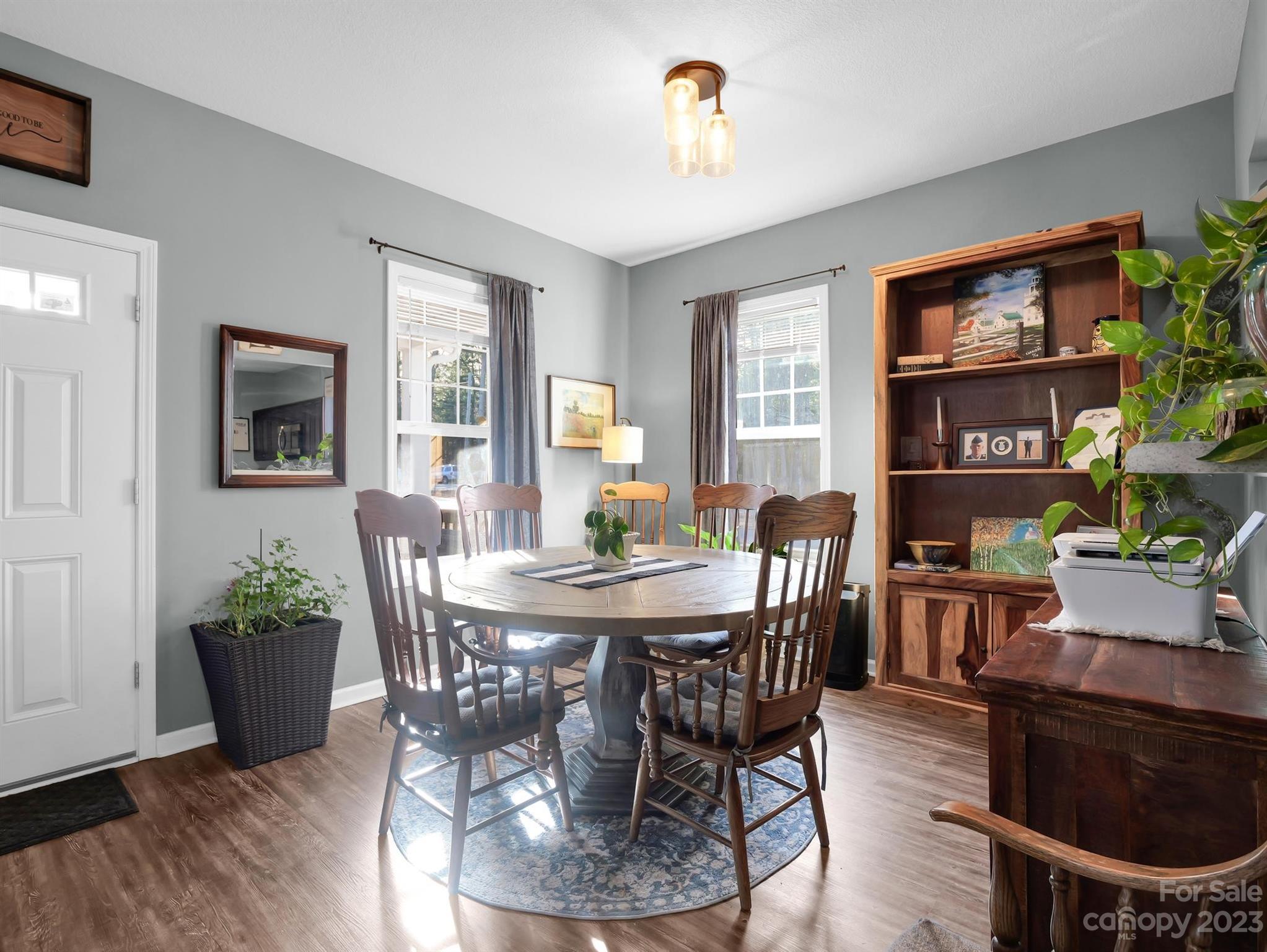 335 Mine Gap Road Flat Rock, NC 28731 - Photo 7 of 40 a view of a dining room with furniture window and wooden floor
