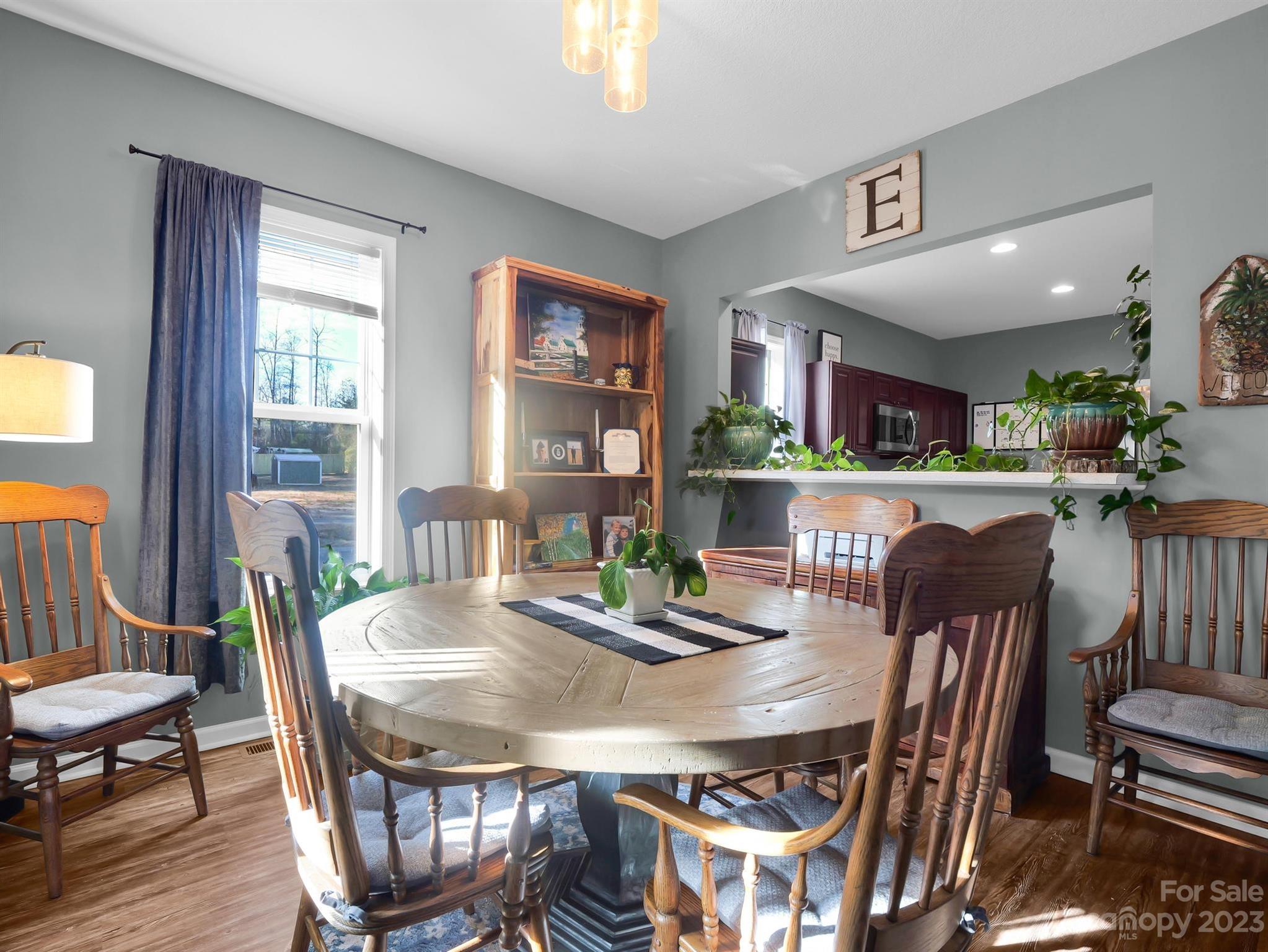335 Mine Gap Road Flat Rock, NC 28731 - Photo 8 of 40 a view of a dining room with furniture window and wooden floor