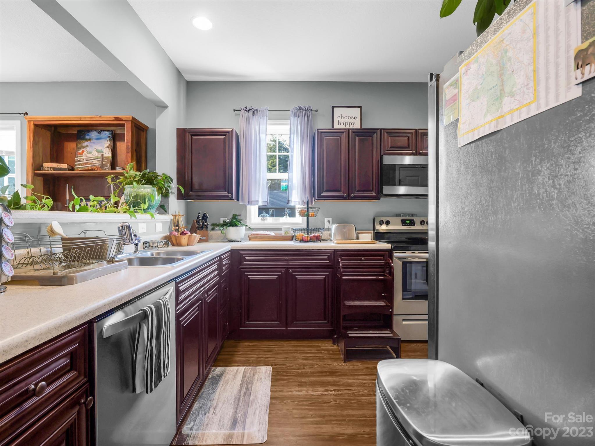 335 Mine Gap Road Flat Rock, NC 28731 - Photo 10 of 40 a kitchen with stainless steel appliances granite countertop a sink and a stove