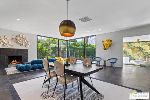 a dining room with furniture a rug and a chandelier