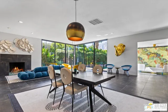 a dining room with furniture a rug and a chandelier