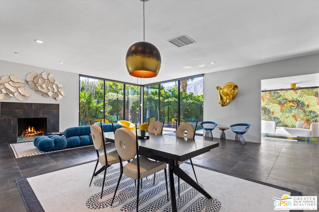 1075 East Suntan Lane Palm Springs, CA 92264 - Photo 11 of 39 a living room with furniture a fireplace and a large window