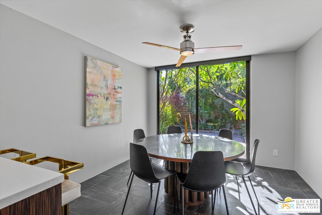 1075 East Suntan Lane Palm Springs, CA 92264 - Photo 17 of 39 a dining room with furniture a chandelier and wooden floor