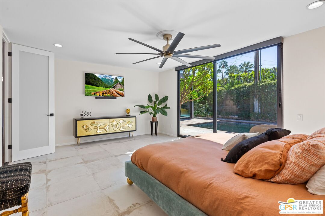 1075 East Suntan Lane Palm Springs, CA 92264 - Photo 22 of 39 a bedroom with a bed and a large window